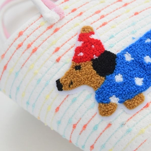 Detailed macro view of woven rope texture with a cute puppy embroidery patch and colorful waves