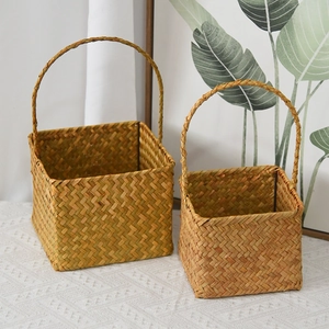 Detail of two-piece rectangular woven seagrass baskets with sturdy high arch handles