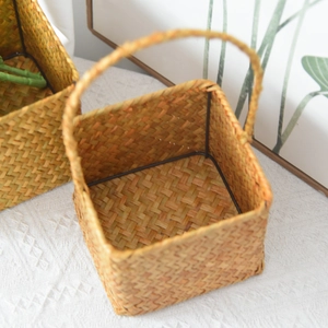 Detail of hand-woven seagrass basket with sturdy black metal frame for home storage