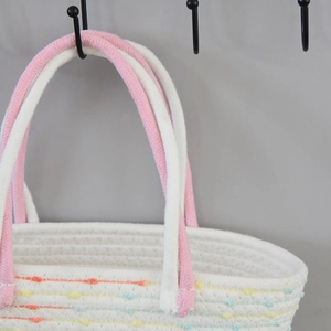 Close-up detail of the hand-woven texture and colorful polka dots on this beach tote bag