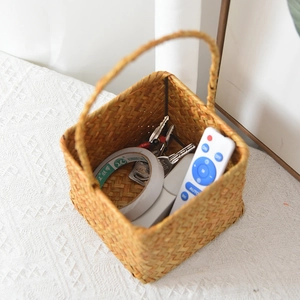 Macro detail of hand-woven square rattan flower basket with handle for desk storage
