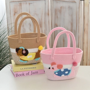Detail showing hand-woven cotton rope baskets with cute dog and mouse animal patterns