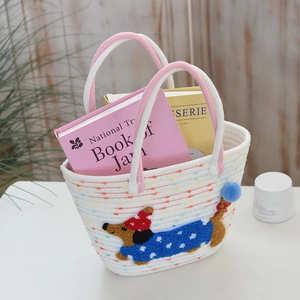 Detail of white woven tote bag with dachshund embroidery and colorful dots texture