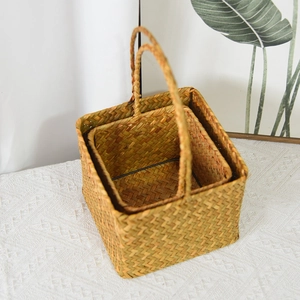 Detailed close-up of natural seagrass woven baskets set showing texture and sturdy handles