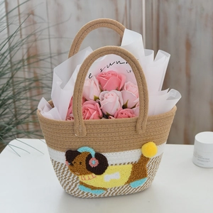 Detailed view of hand-woven gift basket featuring cartoon puppy and faux soap roses