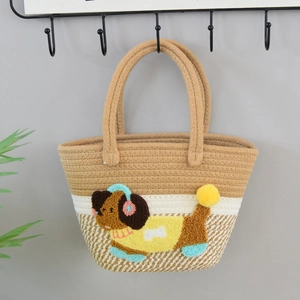 Close-up of woven tote bag with 3D plush puppy decoration and dual round handles