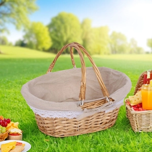Detail of hand-woven wicker picnic basket with lace lining on a sunny outdoor grass