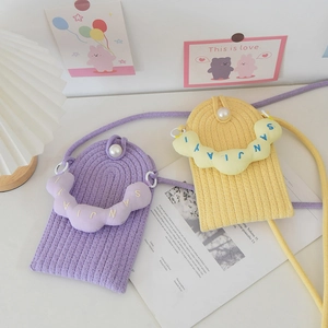 Close-up of hand-woven mini pearl bags with cloud details and knit texture