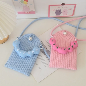 Detail of hand-woven mini crossbody bags in blue and pink with elegant pearl buckle