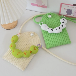 Close-up of woven pearl mini shoulder bags in cream white and vibrant green colors