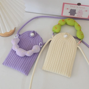 Close-up of handmade woven pearl phone bags in purple and white with embroidered handles