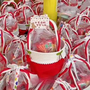 Detail of woven gift basket with red cherry decor and Happy Day ribbon packaging
