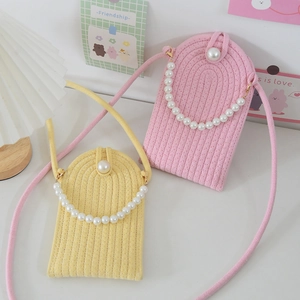 Detailed view of woven phone bag featuring vertical knit texture and large pearl buckle