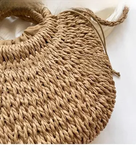 Close-up detail of hand-woven straw bag texture with secure drawstring inner lining