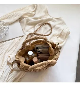 Internal view of the woven beach bag showing large capacity with phone, wallet and bottle