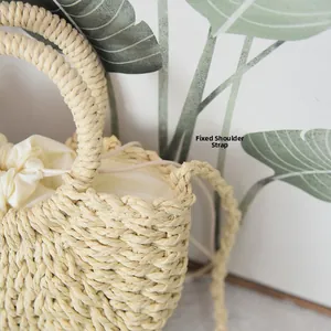 Detail of woven straw bag showing thick texture and white drawstring fabric lining