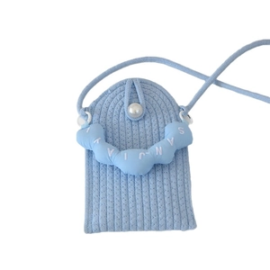Mini light blue woven crossbody phone bag featuring a pearl button and cloud patch