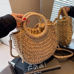 Detail of hand-woven straw handbag featuring a drawstring lining and round handles