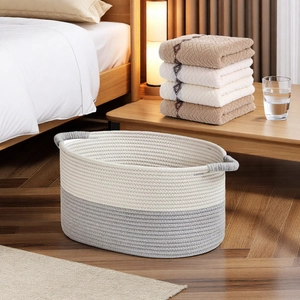 Close-up of woven cotton rope storage basket with dual-tone grey and cream design