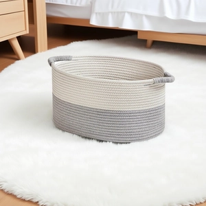 Close-up of woven cotton storage basket featuring a two-tone gray and white design
