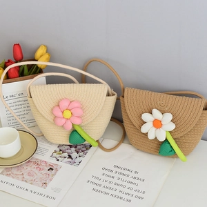 Detail of woven straw mini bags featuring large 3D fabric flowers and green leaf accents