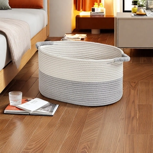 Detail of woven cotton rope storage basket with dual-tone grey and white stitching