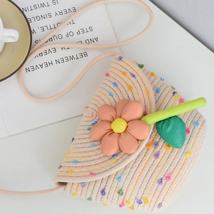Detailed macro view of woven beige mini bag with colorful polka dots and orange flower deco