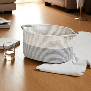 Detail of grey and white cotton rope woven storage basket with integrated side handles