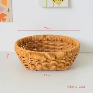 Detailed view of handwoven 20x13x7cm rattan-style basket for fruit or bread storage