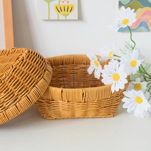 Detailed texture of hand-woven storage basket with matching lid on a minimalist white desk