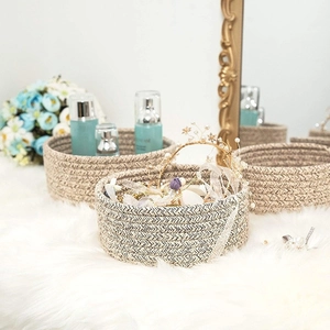 Three-piece nesting set of round woven cotton rope storage baskets in beige and brown