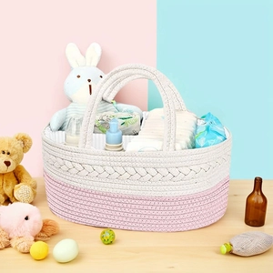 Detail view of cotton rope diaper caddy with woven handles and pink white stitching