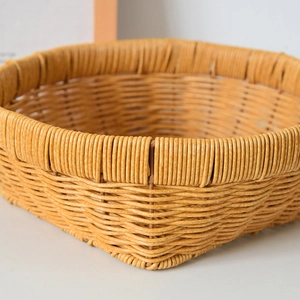 Close-up of woven rattan-style storage basket with detailed texture and durable rim