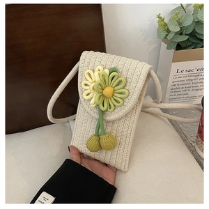 Detailed shot of handmade crochet phone bag in cream with 3D floral accents
