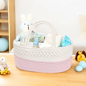 Close-up of pink and white woven cotton rope baby diaper caddy organizer basket
