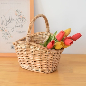 Detailed close-up of handmade wicker storage basket with decorative tulips on a wooden surface