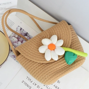 Mini woven straw crossbody bag with white daisy flowers for summer beach vacations