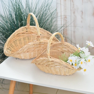 Close-up of a set of two natural handmade wicker baskets with sturdy handles and daisies