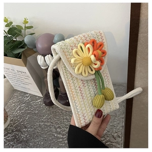 Close-up of hand-woven crochet crossbody bag with colorful waves and flower detail