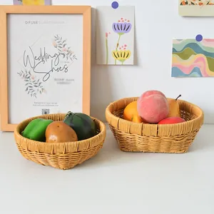 Detailed close-up of woven rattan storage baskets used as fruit bowls in a home setting