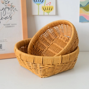 Detail of two-piece woven storage basket set with honey color finish and reinforced edges
