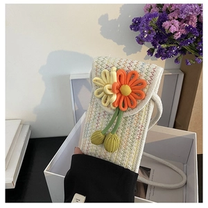 Close-up of handmade woven phone bag featuring crochet sunflowers and wave texture