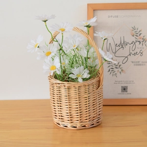 Handwoven wicker storage basket with white daisies and a sturdy handle for home decor