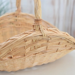 Detailed close-up of a handmade willow picnic basket with a reinforced sturdy handle