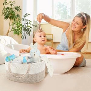 Detail of hand-woven cotton rope diaper caddy showing spacious storage for baby essentials
