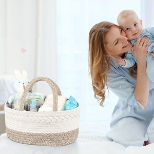 Detail of cotton rope baby diaper caddy with dividers holding diapers and toys