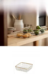 Detail of iron wire storage basket with wooden rim for fruit and kitchen organization