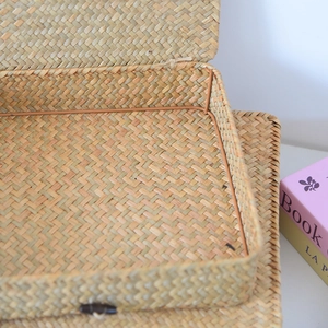 Detail of handwoven seagrass storage box featuring a natural texture and button lock