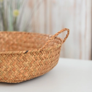 Close-up of woven seagrass basket texture with durable handles for home storage