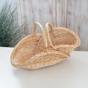 Close-up of handmade wicker storage basket with sturdy double handles and natural texture